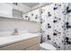 Bathroom featuring a Mickey Mouse-themed shower curtain, mirrored cabinet, and a sink with a white countertop at 1705 Monroe Ne Dr # E3, Atlanta, GA 30324