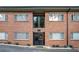 Exterior view of a well maintained brick apartment building with black door at 1705 Monroe Ne Dr # E3, Atlanta, GA 30324