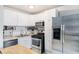 A modern kitchen features white cabinets and stainless steel appliances at 1705 Monroe Ne Dr # E3, Atlanta, GA 30324