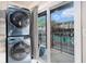Laundry machines offer convenience and style near a sliding glass door to a patio and pool at 1705 Monroe Ne Dr # E3, Atlanta, GA 30324