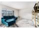 Open living area featuring a teal sofa, stylish decor, and lots of natural light at 1705 Monroe Ne Dr # E3, Atlanta, GA 30324