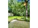 A lush backyard with a detached garage or shed surrounded by trees at 287 Willow Cove Ct, Lawrenceville, GA 30044