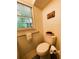 Cozy bathroom with a comfort height toilet, textured walls, and a window at 287 Willow Cove Ct, Lawrenceville, GA 30044