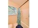 Bathroom with a bathtub, shower curtain, and a window with blinds at 287 Willow Cove Ct, Lawrenceville, GA 30044