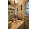 Well-lit bathroom featuring a sink, vanity, and decorative candle lighting fixtures at 287 Willow Cove Ct, Lawrenceville, GA 30044