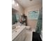 Bathroom featuring a vanity sink, toilet, mirror, shower with curtain, and window at 287 Willow Cove Ct, Lawrenceville, GA 30044