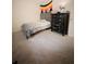 Cozy bedroom featuring a bed and dresser with neutral-toned walls and carpet at 287 Willow Cove Ct, Lawrenceville, GA 30044