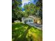 Charming two-story home featuring lush green lawn, classic black shutters, and lovely trees surrounding the property at 287 Willow Cove Ct, Lawrenceville, GA 30044