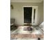 A covered front porch featuring a classic black door with sidelight and 'welcome' mat, creating a warm entry to the home at 287 Willow Cove Ct, Lawrenceville, GA 30044