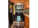 Close up of stainless steel appliances and tile backsplash in this functional kitchen at 287 Willow Cove Ct, Lawrenceville, GA 30044