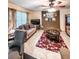 Cozy living room with patterned rug, large windows, and brick fireplace at 287 Willow Cove Ct, Lawrenceville, GA 30044