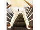 A staircase with carpeted steps leads downwards, featuring white railings and wooden handrails at 287 Willow Cove Ct, Lawrenceville, GA 30044