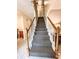 An interior view of a carpeted staircase with wood banister, creating a warm entry to the home at 287 Willow Cove Ct, Lawrenceville, GA 30044