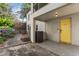 Back porch with painted yellow door featuring a 