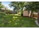 Large, green backyard featuring a shed, mature trees, and a well-maintained lawn at 3158 Granby Ave, Scottdale, GA 30079