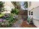 Backyard featuring a lush garden with hydrangeas, a wooden fence, and a cozy, well-maintained space at 3158 Granby Ave, Scottdale, GA 30079