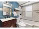 Charming bathroom featuring stylish blue walls, subway tile with black trim, and a modern vanity at 3158 Granby Ave, Scottdale, GA 30079