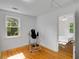 Light-filled bedroom with hardwood floors and a view to another room at 3158 Granby Ave, Scottdale, GA 30079