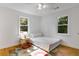 Cozy bedroom featuring two windows and a colorful rug on hardwood floors at 3158 Granby Ave, Scottdale, GA 30079