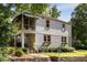 Charming home with a welcoming yellow front door, a screened porch, and a beautifully landscaped yard at 3158 Granby Ave, Scottdale, GA 30079