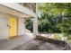 Inviting front porch features a yellow door, partial view of road, and space for outdoor seating at 3158 Granby Ave, Scottdale, GA 30079