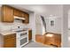 Cozy kitchen with bright lighting showcasing wooden cabinets, white oven, with view to living room at 3158 Granby Ave, Scottdale, GA 30079