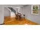 Bright living room with hardwood floors, staircase, and plenty of natural light from the large window at 3158 Granby Ave, Scottdale, GA 30079
