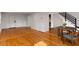 Living room with hardwood floors, a dining table, view of stairs, and white walls offering a bright and inviting space at 3158 Granby Ave, Scottdale, GA 30079