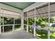 View of a relaxing screened porch area with natural light and a treelined vista at 3158 Granby Ave, Scottdale, GA 30079