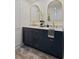 Bathroom featuring a double sink vanity, dark blue cabinets, gold fixtures, and a modern rug at 3777 Peachtree Ne Rd # 1227, Brookhaven, GA 30319