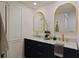 Bathroom with double sink vanity, marble countertop, gold fixtures, and decorative mirrors at 3777 Peachtree Ne Rd # 1227, Brookhaven, GA 30319