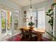 Bright dining room with hardwood table, seating, balcony access, and plenty of natural light at 3777 Peachtree Ne Rd # 1227, Brookhaven, GA 30319