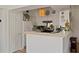 Bright kitchen featuring white cabinets, breakfast bar, and appliances with access to the bedroom at 3777 Peachtree Ne Rd # 1227, Brookhaven, GA 30319
