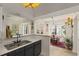 Bright kitchen features stainless steel sink, view into dining area with wood floors, and lots of natural light at 3777 Peachtree Ne Rd # 1227, Brookhaven, GA 30319