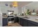 Well-lit kitchen features black and white cabinets, stainless appliances and mirrored backsplash at 3777 Peachtree Ne Rd # 1227, Brookhaven, GA 30319
