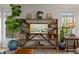 Stylish living room features a decorative wooden shelf and abundant natural light from two windows at 3777 Peachtree Ne Rd # 1227, Brookhaven, GA 30319