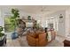 Comfortable living room with a large bookcase, leather sofa, and bright windows at 3777 Peachtree Ne Rd # 1227, Brookhaven, GA 30319