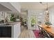 Open living space featuring the kitchen bar, living room, dining space and sliding doors to a deck at 3777 Peachtree Ne Rd # 1227, Brookhaven, GA 30319