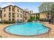 Inviting community pool surrounded by manicured gardens and residential buildings for leisure and recreation at 3777 Peachtree Ne Rd # 1227, Brookhaven, GA 30319