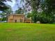 Large backyard with lush green lawn and convenient storage shed, surrounded by mature trees for added privacy at 4086 Rex Road, Rex, GA 30273