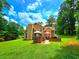 Backyard view with a brick patio area, ideal for relaxation, and a beautiful green lawn at 4086 Rex Road, Rex, GA 30273