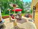 Patio with two heaters, umbrellas, outdoor furniture, and lots of trees at 4086 Rex Road, Rex, GA 30273