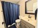 Cozy bathroom featuring a large vanity and shower with curtain at 4086 Rex Road, Rex, GA 30273