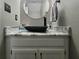 Bathroom with a black basin sink and a round mirror at 4086 Rex Road, Rex, GA 30273