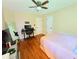 Bright bedroom features hardwood floors, ceiling fan, desk and chair at 4086 Rex Road, Rex, GA 30273