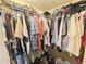 Walk-in closet with clothing racks and shelves full of clothes and shoes at 4086 Rex Road, Rex, GA 30273