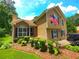Exterior view of a charming home featuring a brick accent, neat landscaping, and a welcoming entrance at 4086 Rex Road, Rex, GA 30273