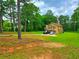 Two-story home with green lawn, ample parking, and a cozy, welcoming appearance amidst mature trees at 4086 Rex Road, Rex, GA 30273