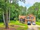 Two-story home featuring a front yard, manicured lawn, and a traditional architectural style at 4086 Rex Road, Rex, GA 30273