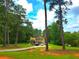 Classic two-story home nestled among tall trees, with an expansive grassy front yard and driveway at 4086 Rex Road, Rex, GA 30273
